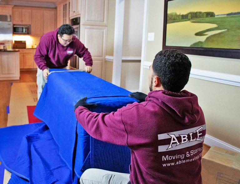Able Moving & Storage team members moving furniture